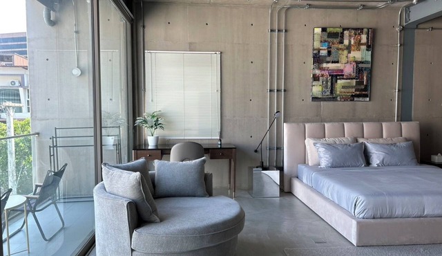 Cozy loft-style rooms, private baths, free Wi-Fi, A/C, and shared spaces.